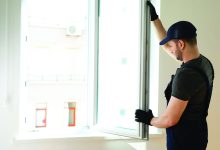 A man replacing his windows following home maintenance tips
